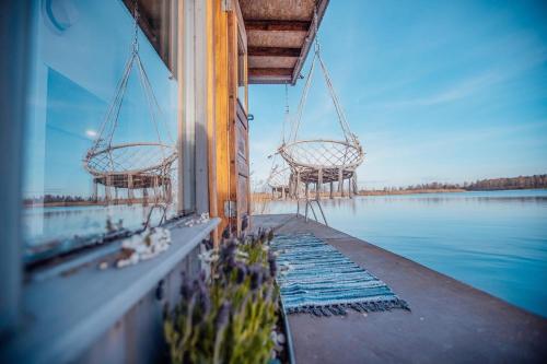 a view of the water from a dock with two baskets at Dzintarkrasts in Jūrmala
