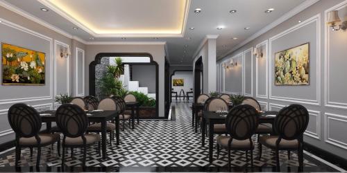 a restaurant with tables and chairs in a room at La Palm Hotel in Hanoi