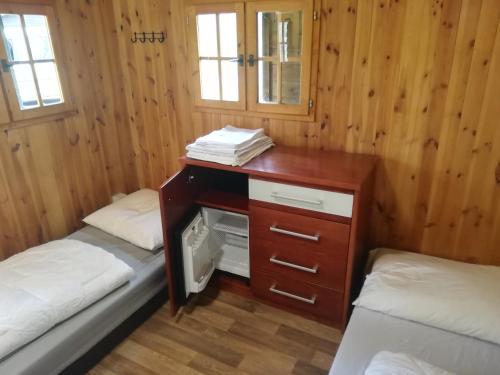 a room with two beds and a desk in a cabin at Sport kemp Ejpovice in Ejpovice
