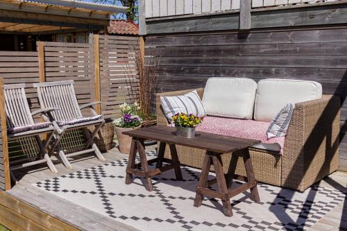 a patio with two chairs and a coffee table at Rosenhill Bed & Breakfast in Grebbestad