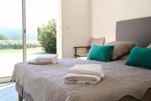 a bedroom with a bed with towels on it at Domaine de La Font des Pères - Teritoria in Le Beausset