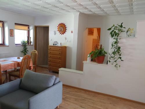 a living room with a couch and a table at Ubytovanie Privat Antoni - apartmán v RD in Tvrdošín