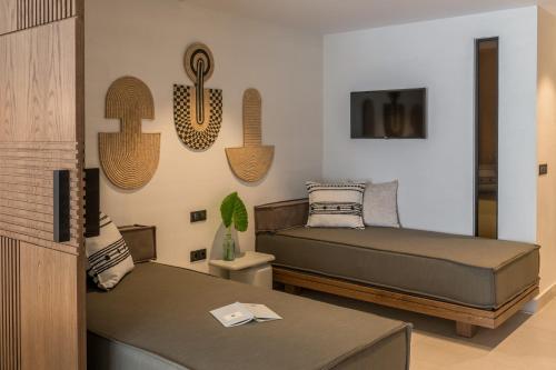 a bedroom with two beds and a table in it at Fodele Beach Water Park Resort in Fodele