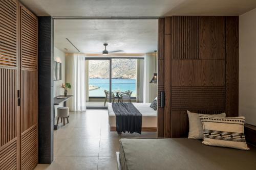 a bedroom with a bed and a view of the ocean at Fodele Beach Water Park Resort in Fodele