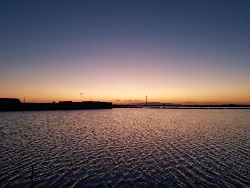 a sunset over a large body of water at Sunset in Trapani