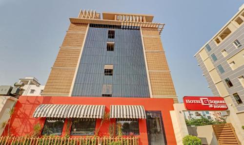 a tall building with a clock on top of it at Itsy By Treebo - G Square in Vijayawāda