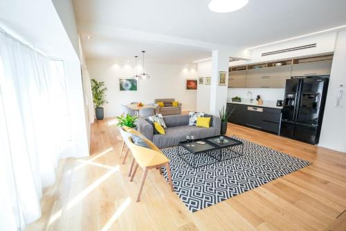 a living room with a couch and a table at DeBlox living - Ibn Gabirol Apartments in Tel Aviv