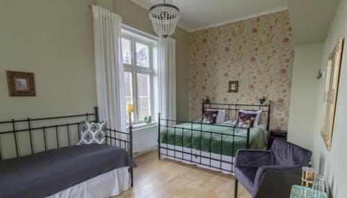 En eller flere senger på et rom på Rosenhill Bed & Breakfast