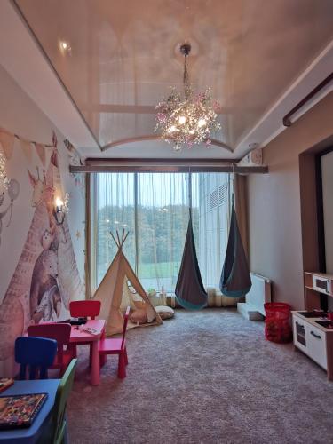 a living room with tents and a chandelier at Hotel Mistral Sport in Gniewino