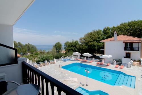 a villa with a swimming pool and a balcony at Iro's Residence in Ágios Konstantínos