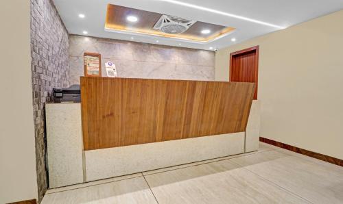 a reception desk in a room with a wooden partition at Itsy Hotels G Square in Vijayawāda