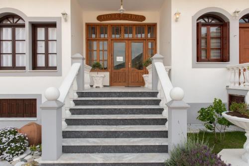 a house with stairs leading to the front door at Iro's Residence in Ágios Konstantínos