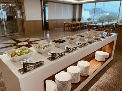uma linha de buffet com tigelas e pratos de comida em Kumho Tongyeong Marina Resort em Tongyeong