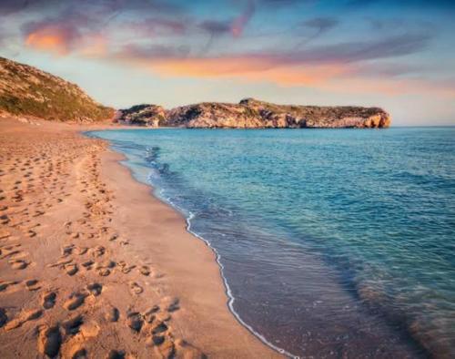 a view of a beach with footprints in the sand at Eucalyptus Pension in Patara