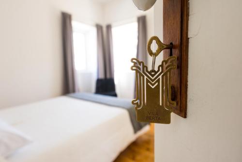 a close up of a bedroom with a bed at 3 Marias Residence in Viana do Castelo