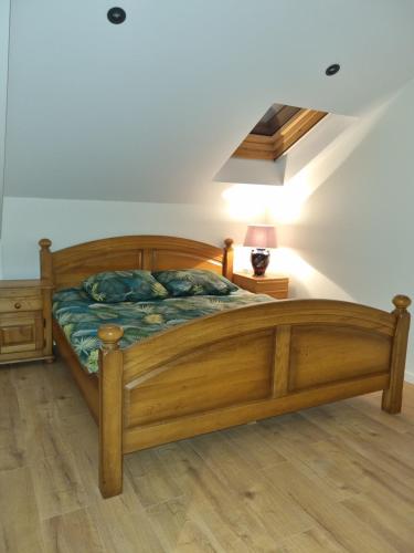a bedroom with a wooden bed and a lamp on a floor at Susberg 4 in Pelt