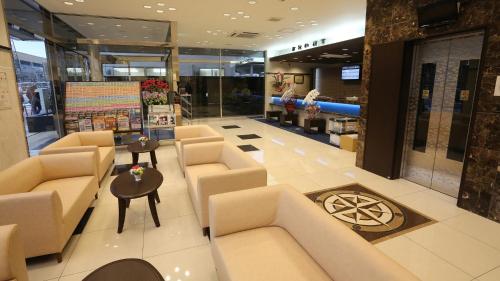 a lobby with couches and tables in a store at Toyoko Inn Shin takaoka eki Shinkansen Minami guchi in Takaoka