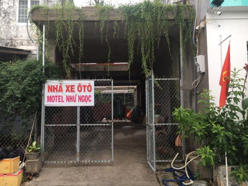 a gate with a sign in front of a garage at Như Ngọc Motel in Cà Mau