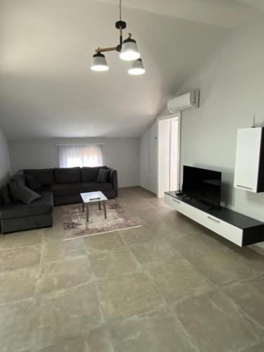 a living room with a couch and a table at Eagle’s Nest in Shkodër