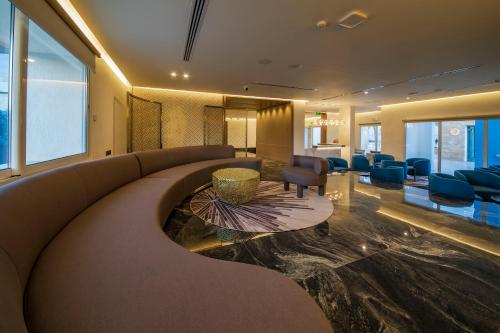 a lobby with a couch and a waiting room at Luxotel Aqaba Beach Resort & Spa Only 15 years plus in Aqaba