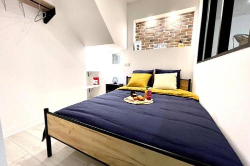 a bedroom with a bed with a plate of food on it at The New-Yorker - hyper centre- 2mn gare SNCF - Wi-Fi Netflix gratuit in Niort