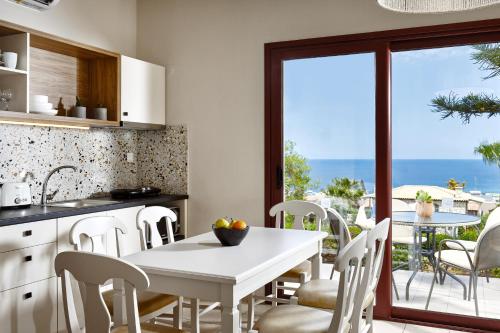 a kitchen and dining room with a table and chairs at Marni Village in Hersonissos