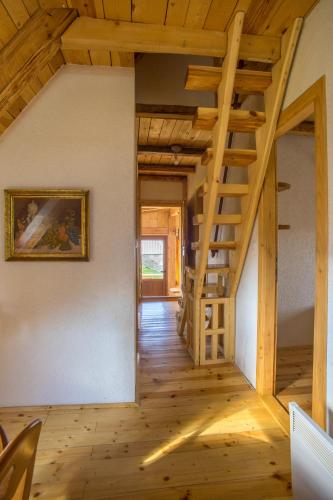 a room with a wooden staircase in a house at Maple village in Žabljak
