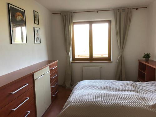 a bedroom with a bed and a window at Apartmán 316 in Donovaly