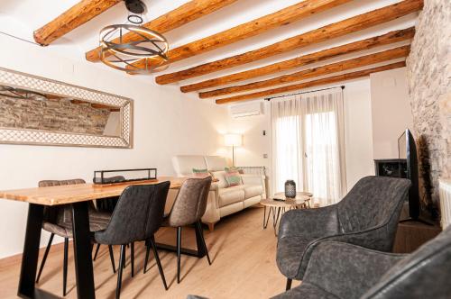 a living room with a table and chairs and a couch at Casa Nicole in Portell