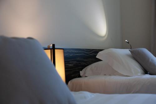 Postel nebo postele na pokoji v ubytování G Hotel Ancona