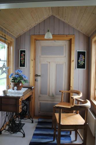 a room with a wooden door and a table and chairs at Hov Feriehus in Gimsøy