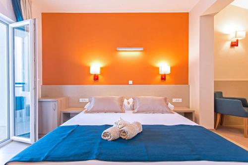 a bedroom with a bed with two towels on it at Apartments Villa Loznica in Brela