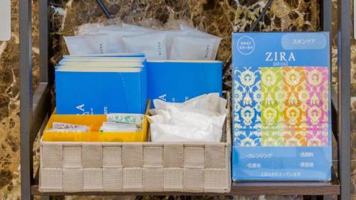 a shelf filled with different boxes on a table at Toyoko Inn Matsumoto eki Higashi guchi in Matsumoto