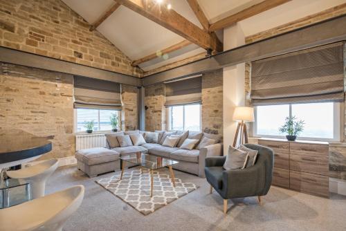 a living room with a brick wall at Heritage Serviced Suites - Serviced Apartments in Huddersfield