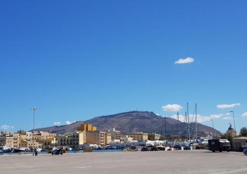 a large parking lot with a city and a mountain at Sunset in Trapani