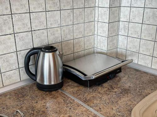 a tea kettle sitting on top of a kitchen counter at Nouvelle Vie Living in Potos