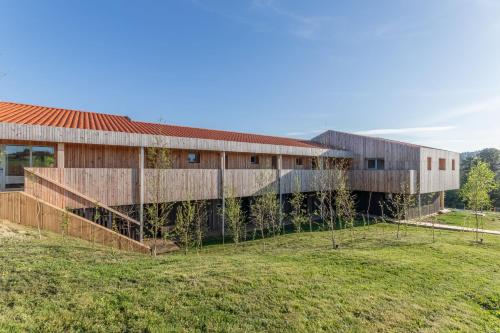 an external view of a building with trees at Basoan in Mungia