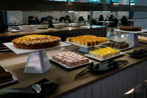 a buffet line with different types of cakes and desserts at Alua Tenerife in Puerto de la Cruz