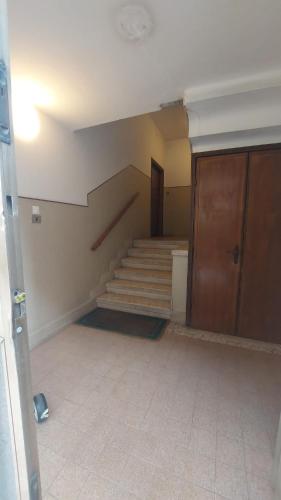 an empty room with stairs and a door at Marconi Rooms and Apartments in Verona