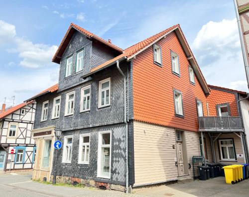 a black and orange building with an orange roof at Ferienwohnungen Albarts by Mountain apart in Wernigerode