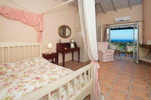 a bedroom with a bed and a view of the ocean at Villa Maria Kefalonia in Kaligata