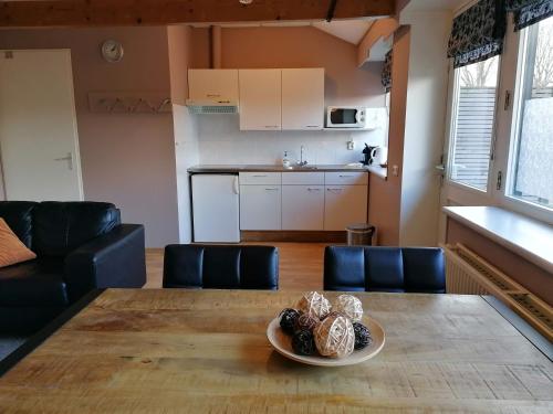 a kitchen and a table with a plate of food on it at Hotel Lemmenhof in Ell