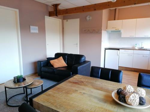 a living room with a table and a couch at Hotel Lemmenhof in Ell