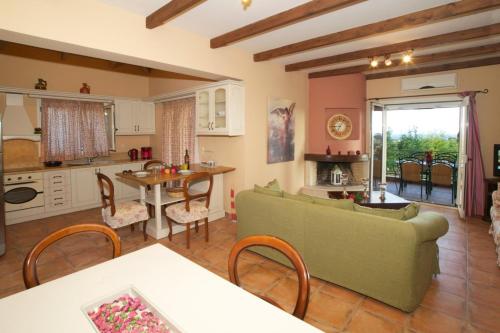 a living room with a couch and a table at Villa Maria Kefalonia in Kaligata
