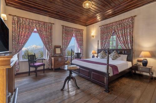 a bedroom with a large bed and two windows at Sterling Park Kalimpong in Kalimpong