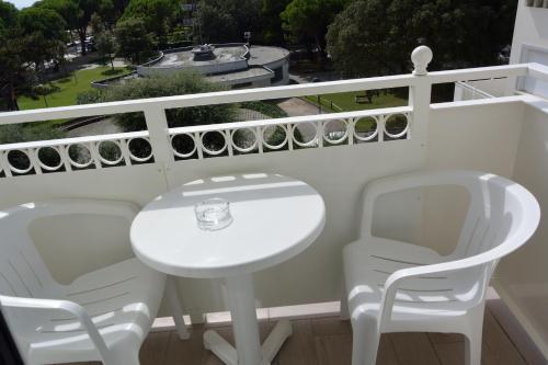 a white table and chairs on a balcony at Hotel Miramare in Lignano Sabbiadoro