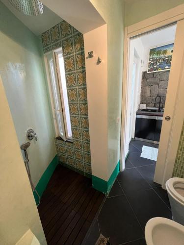 a bathroom with a toilet and a sink at Smeraldino in Ischia