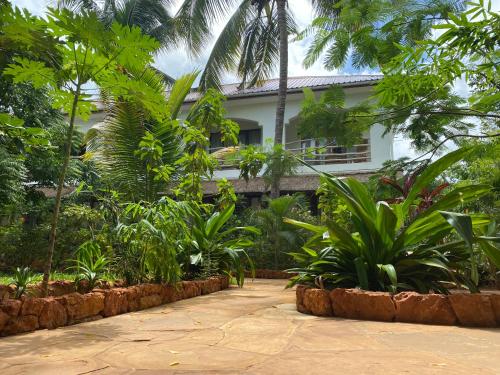 a house in the middle of a garden at Siri Beach Lodge in Nungwi
