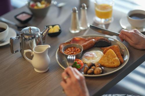 a breakfast plate of breakfast foods on a table at The Lodge Hotel in Coleraine