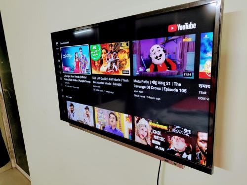 a television screen with a bunch of videos at Entire Studio Apt/Suite near Mall/Metro/ExpoMart in Noida